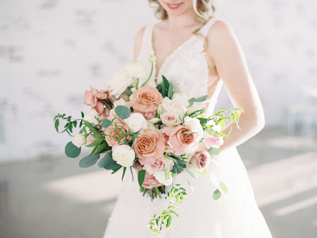 Dallas wedding photographer | indoor bridal portrait of bride holding bouquet at Firefly Gardens