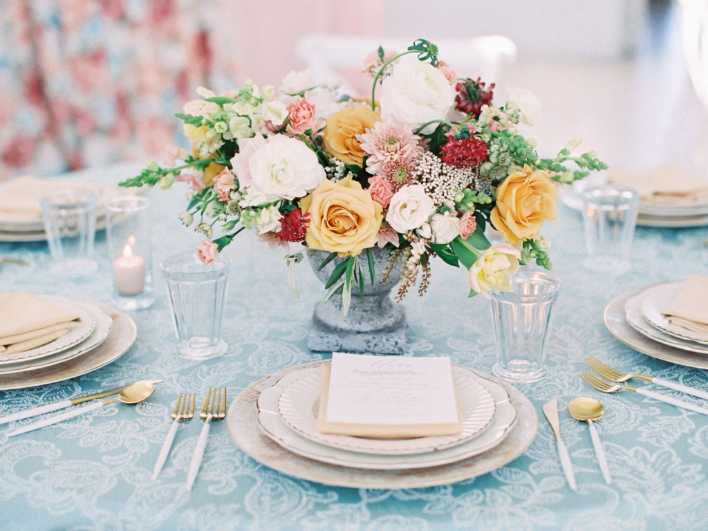 Wedding reception florals on pattered table cloth